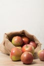 Cloth bag with apples. Burlap sack with rustic apples Royalty Free Stock Photo