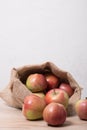 Cloth bag with apples. Burlap sack with rustic apples on food Royalty Free Stock Photo