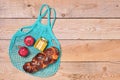 Cloth bag with pomegranates, honey and challah, reusable material for natural products. Zero waste concept. Hanukkah. Conscious