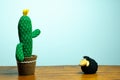 Cloth cactus and black sheep on wooden table and white background Royalty Free Stock Photo