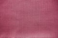 Cloth close-up. Interlacing of threads. A piece of pink fabric. Fabric background. Copy space