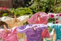 Cloth diapers hanging while drying under the sun on clothesline. Laundry of colorful reusable nappies for babies