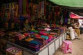 Cloth and fabric vendor, selling bright coloured products at Nyaung Shwe day market, near Inle Lake