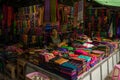 Cloth and fabric vendor, selling bright coloured products at Nyaung Shwe day market, near Inle Lake
