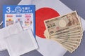 Cloth masks, leaflet and 100,000 yen cash to fight COVID-19 on Japan flag.