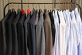 A cloth rack filled with suits