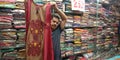 a cloth seller displayed women party wear dress into the store