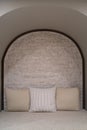 Cloth sofa with brown pillows and brick wall Royalty Free Stock Photo