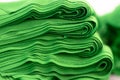 Cloth sports mesh folded into a stack of bright green color close-up.