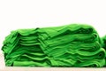 Cloth sports mesh folded into a stack of bright green color close-up.