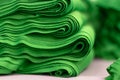 Cloth sports mesh folded into a stack of bright green color close-up.