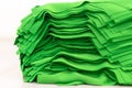 Cloth sports mesh folded into a stack of bright green color close-up.