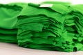 Cloth sports mesh folded into a stack of bright green color close-up.