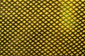 Textiles. Fabric background with mesh. The mesh piece of fabric is yellow in color. Grid