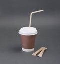 Clotheded take-out coffee with cup holder on gray background. Royalty Free Stock Photo