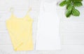 Clothes background top view, accessories summer concept t-shirt mock up on wooden floor, fashion shirt empty for logo, empty