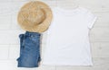 Clothes background top view, accessories summer concept t-shirt mock up on wooden floor, fashion shirt empty for logo, empty