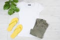 Clothes background top view, accessories summer concept t-shirt mock up on wooden floor, fashion shirt empty for logo, empty