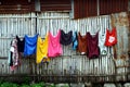 Clothes in a clothes line being hung to dry Royalty Free Stock Photo