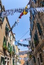 Clothes on a clothesline in a narrow street in Venice Royalty Free Stock Photo