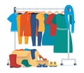 Clothes for donation. Various clothes on a hanger and in boxes, shoes. Cheap and free seasonal garment. Second hand shop, flea Royalty Free Stock Photo