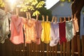 Clothes drying on a clothesline on a sunny summer day. children\'s colorful clothing drying, AI Generated Royalty Free Stock Photo