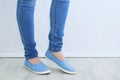 Clothes and footwear. Legs of caucasian woman in skinny jeans and blue shoes close up Royalty Free Stock Photo