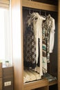 Clothes hang on a shelf in a designer clothes store, modern closet with row of cloths hanging in wardrobe, vintage rooms Royalty Free Stock Photo