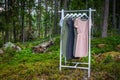 Clothes hanger with dresses in the woods.