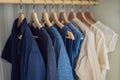 Clothes on hangers in the cabinet gradient from white to dark bl Royalty Free Stock Photo