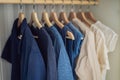 Clothes on hangers in the cabinet gradient from white to dark blue Royalty Free Stock Photo