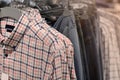 Clothes on hangers in store. Mens shirts hang on clothing rack. Shopping time concept