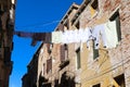 clothes hanging and linen drying in the sun in the narrow alley between the houses Royalty Free Stock Photo