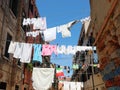 clothes hanging out drying in the sun in the narrow street of th Royalty Free Stock Photo