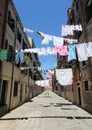 Clothes hanging out to dry in the sun in the alley called CALLE Royalty Free Stock Photo