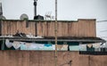 Clothes hanging on a rope at the top of a building, surrounded by antennas and chimneys. Urban landscape Royalty Free Stock Photo