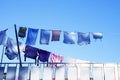 Clothes hanging to dry on a clothesline outdoors against a blue sky on a sunny day. Royalty Free Stock Photo