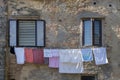 Clothes hanging under a window on a brick wall Royalty Free Stock Photo