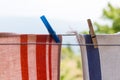 Clothes hanging up with pegs outside.