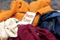 Clothes heap. there is a large pile of sketched clothes, notebook with please donate, coat drive, donation concept Royalty Free Stock Photo