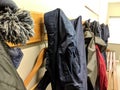 Clothes hung up on pegs in a changing room with coat hanger