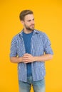 Clothes for daily life. Handsome man unshaven face and stylish hair. Caucasian man yellow background. Bearded man in