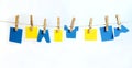 Clothes Line and Pins Holding blue & Yellow Shapes for Text Royalty Free Stock Photo