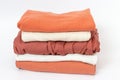 Clothes neatly folded into stack on white background, front view Royalty Free Stock Photo