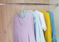 Clothes of pastel shades on hangers. analysis of the wardrobe