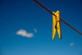 Clothes peg and blue sky background. Royalty Free Stock Photo