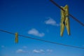 Clothes peg and blue sky background. Royalty Free Stock Photo
