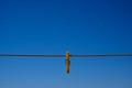 Clothes peg and blue sky background. Royalty Free Stock Photo