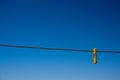 Clothes peg and blue sky background. Royalty Free Stock Photo