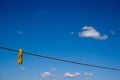 Clothes peg and blue sky background. Royalty Free Stock Photo